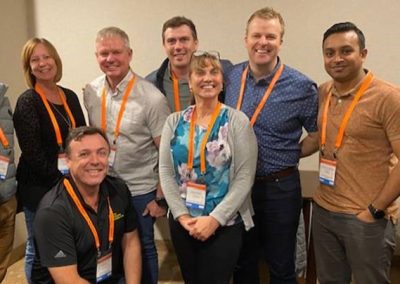A group of people posing for a photo in a conference room involved in construction management.