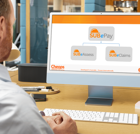 A person views a computer monitor showing a flowchart with "SUB ePay" connected to "SUB eAssess" and "SUB eClaims." The screen displays branding and the text "Developed in Australia. A person views a computer monitor showing a flowchart with "SUB ePay" connected to "SUB eAssess" and "SUB eClaims." The screen displays branding and the text "Developed in Australia.